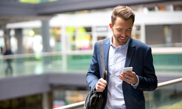 man in a suit checking his phone