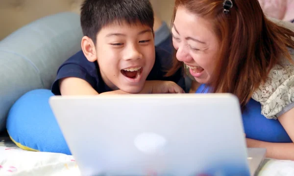 mother and child laughs over online content