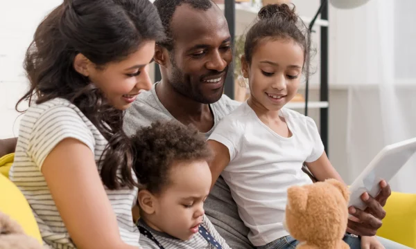 family on a couch using a tablet