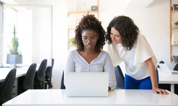 two woman looking at an online content