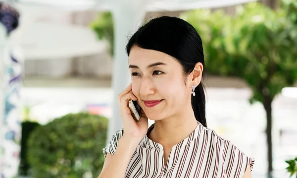 woman smiling through a phone call