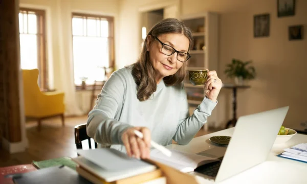 elder woman working online in the morning