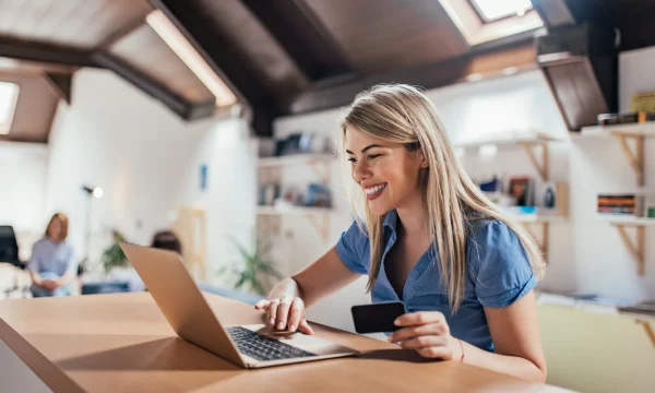 blonde woman happy about making online purchase